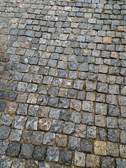 Cobblestone pavement gray. Travel concept. Mobile photo.