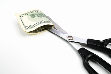 Scissors cut the dollar, on an isolated white background