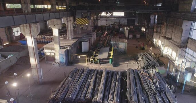 Span over metal in a warehouse. Metal in an indoor warehouse. Metal round billets in a warehouse