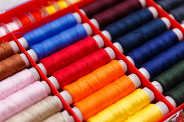 colorful sewing and tailoring tools and items on light background
