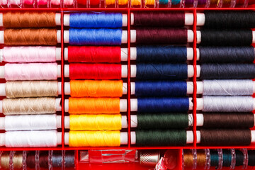 colorful sewing and tailoring tools and items on light background