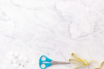 colorful sewing and tailoring tools and items on light background