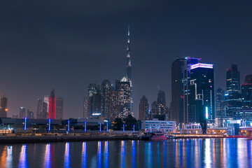Amazing Dubai City Skyline at Night or Blue Hour. View from Dubai water canal business bay, United Arab Emirates.
