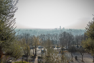 Stunning view over Brescia city view from the old castle on the Cidneo Hill. Lombardy. Smog over the city in nothern Italy. a look of the city 's skyline from a balconyin the castle on Colle Cidneo.