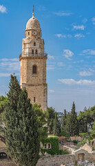 Fototapeta na wymiar Benedictine Dormition Abbey bell tower. Ancient buildings around the Old City in Jerusalem, Israel. The Old City, Jerusalem's historic Center