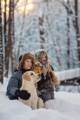 Fototapeta na wymiar brother and sister play in the snow in winter