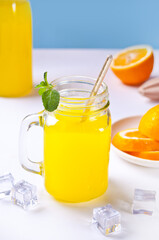Jar of fresh lemonade. Sliced lemon on background.