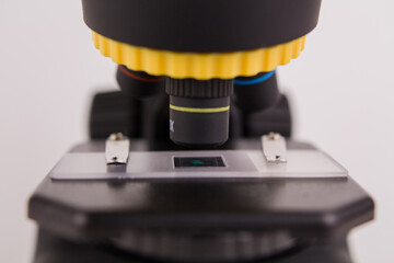 glass for analysis under a microscope with a sample on a white background