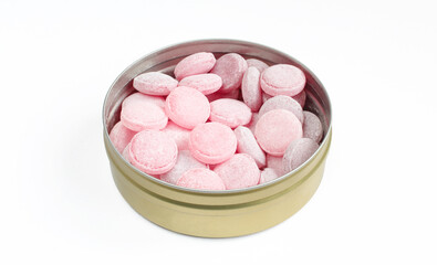 Metallic container full of hard candies isolated on white background. Tasty bonbons