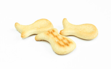 Few salty crackers isolated on white background. Fish shaped snack