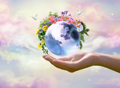 Earth Day or World Environment Day concept. Save our Planet, restore and protect green nature, sustainable lifestyle and Climate literacy theme. Blooming rose, daisy flowers on globe in hand, 22 april