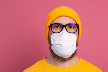 Caucasian young man in glasses with single use medical mask to prevent infection, respiratory disease such as flu
