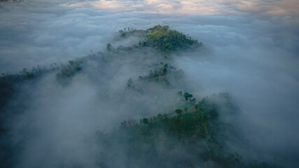 mountains with fog among it, during the morning 