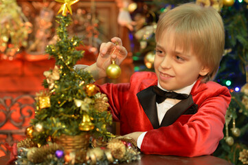 cute boy decorating Christmas tree