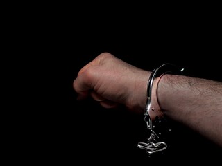 Handcuffs on arrested man hand, man loss freedom