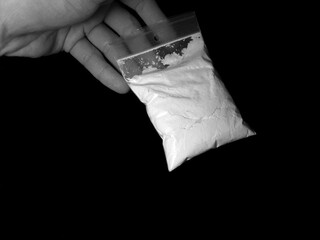 Men holding cocaine drug powder bag during illegal deal