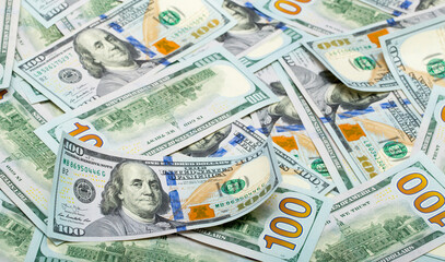 One hundred dollar bills are creatively laid out. Beautiful original cash flow. One hundred bucks as a background on a long banner in high resolution.