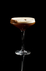 Espresso Martini cocktail isolated on a black background.
