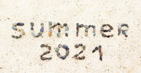 Wurd summer on the sand made from stones. Holiday and vacation concept
