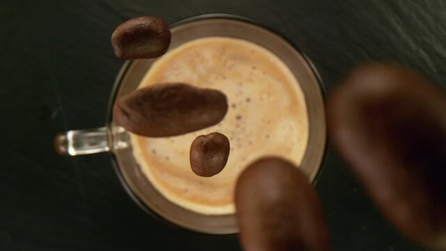 Super slow motion of pouring coffee beans into cup with camera follow. Filmed on high speed cinema camera, 1000 fps.