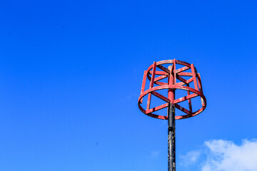 Red beacon against a blue sky