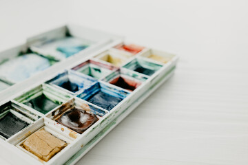 Watercolor in a box on the white background