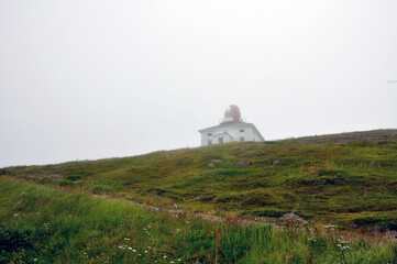 Fototapeta na wymiar A foggy day at the lighthouse at Cape Spear, Newfoundland, the easternmost point in North America. 