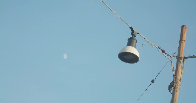 Lamp post with moon in the back