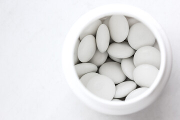 A jar of white round tablets.