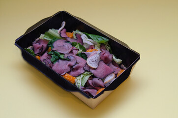 Takeaway food with home delivery. Salad with meat and vegetables in a cardboard box