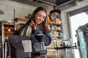 Happy smiling professional barista in cafe