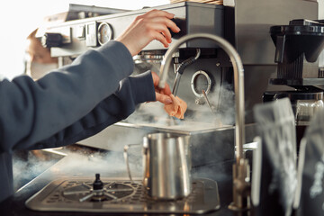 Happy smiling professional barista in cafe