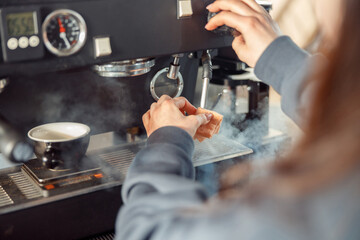 Happy smiling professional barista in cafe