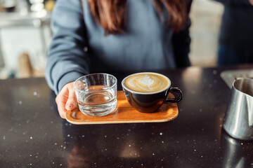 Happy smiling professional barista in cafe