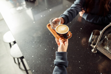 Happy smiling professional barista in cafe