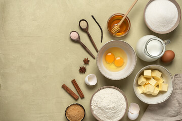Baking background. Baking ingredients are flour, butter, milk, spices, eggs, sugar and honey. Concrete beige background. Top view, flat lay.