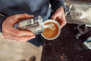 Happy smiling professional barista in cafe