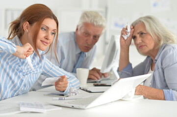 Fototapeta premium Portrait of tired businesspeople working in modern light office