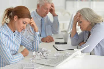 Fototapeta premium Tired businesspeople working in modern light office