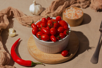 Fermented red cherry tomatoes in a white plate. Vegetarian food. Salted tomatoes. Pickled organic tomatoes. Homemade fermented foods. Food stocks.