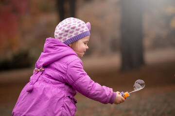Girl, garden, lilac coat, soap bubble blower
