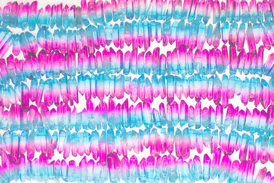 Strands of  colorful, dyed quartz crystals in rows. 