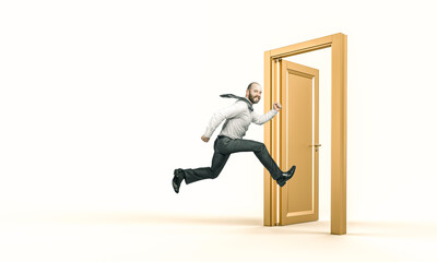 smiling businessman runs and enters a gold door.