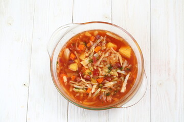 Borscht on white wooden background