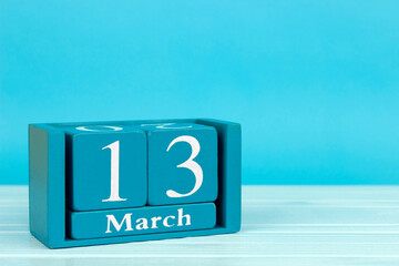 wooden calendar with the date of 
March 13 on a blue wooden background, World Endometriosis Awareness Day; African Scout Day; World Riesling Day	