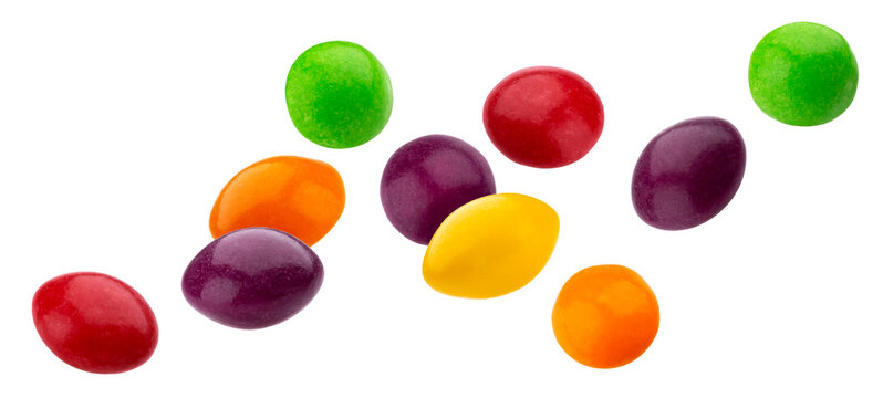 Falling multicolor nuts and raisins dragee isolated on white background
