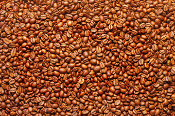 background image: top view of a scattered pile of dark brown coffee beans