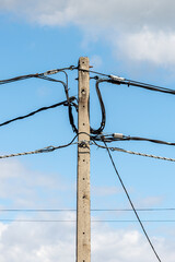 pole with wires on a background of blue sky