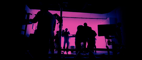 Behind the scenes of shooting video production and lighting set for filming movie which film crew team working in silhouette and professional equipment in studio for video online. video production con - obrazy, fototapety, plakaty