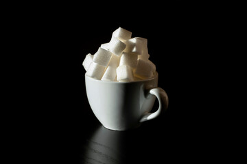 Coffee cup full of sugar cubes